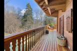 Experience the charm of this rustic wooden balcony, offering stunning views of the surrounding natural landscape.