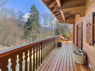 Experience the charm of this rustic wooden balcony, offering stunning views of the surrounding natural landscape.