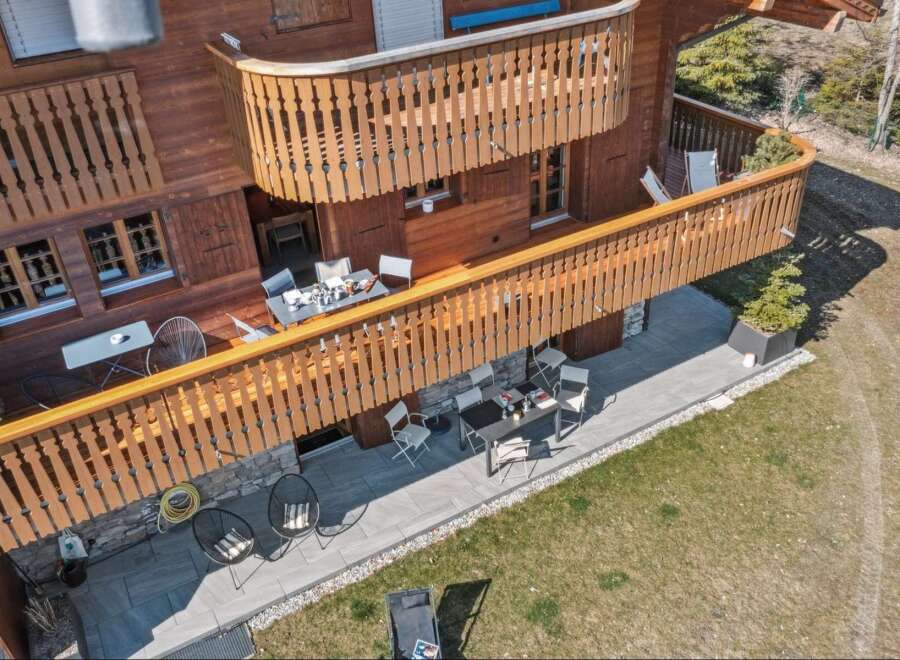 Experience the charm of this wooden chalet featuring multiple balconies and patios perfect for outdoor living.