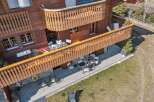 Experience the charm of this wooden chalet featuring multiple balconies and patios perfect for outdoor living.