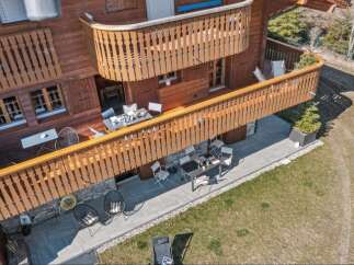Experience the charm of this wooden chalet featuring multiple balconies and patios perfect for outdoor living.