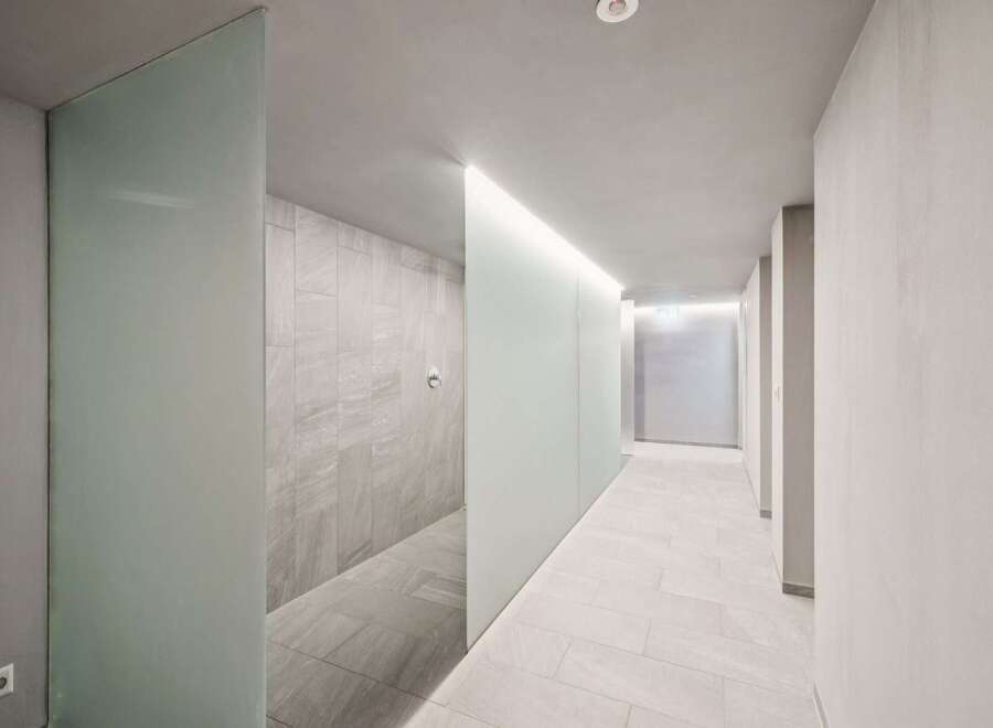 Experience modern luxury in this spacious hallway, featuring sleek frosted glass partitions that create a sense of privacy and sophistication.