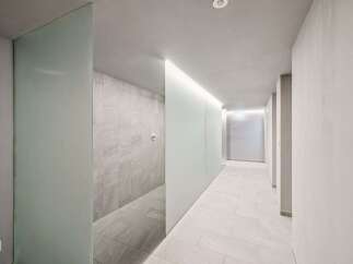 Experience modern luxury in this spacious hallway, featuring sleek frosted glass partitions that create a sense of privacy and sophistication.