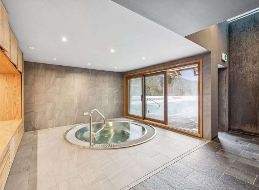Indulge in relaxation in this luxurious spa area, featuring a circular jacuzzi perfect for unwinding.