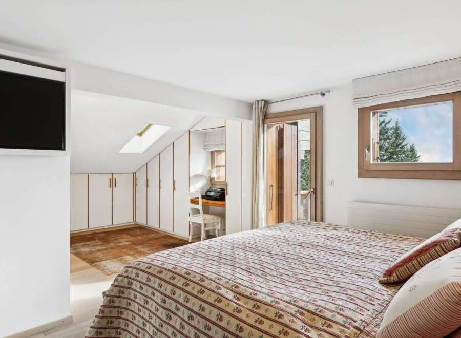 This charming bedroom features a comfortable bed with a patterned comforter, perfect for a cozy retreat.