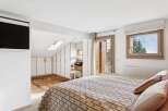 This charming bedroom features a comfortable bed with a patterned comforter, perfect for a cozy retreat.