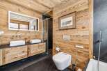 Experience rustic luxury in this stunning bathroom, featuring warm wooden walls and ceilings that create a cozy, natural ambiance.