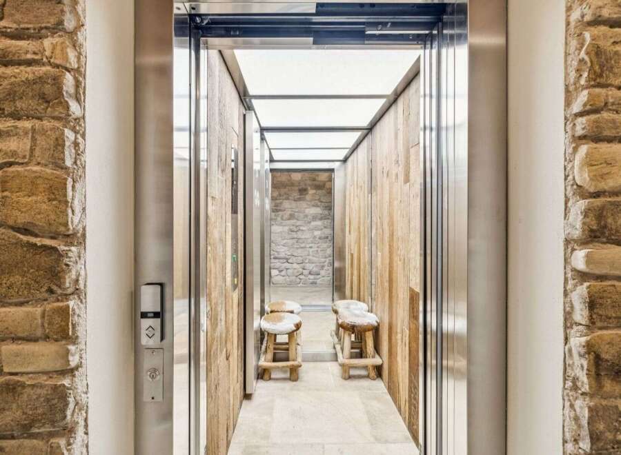 Experience rustic charm and modern convenience in this unique elevator entrance.