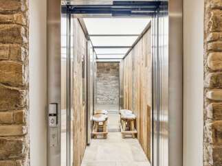 Experience rustic charm and modern convenience in this unique elevator entrance.