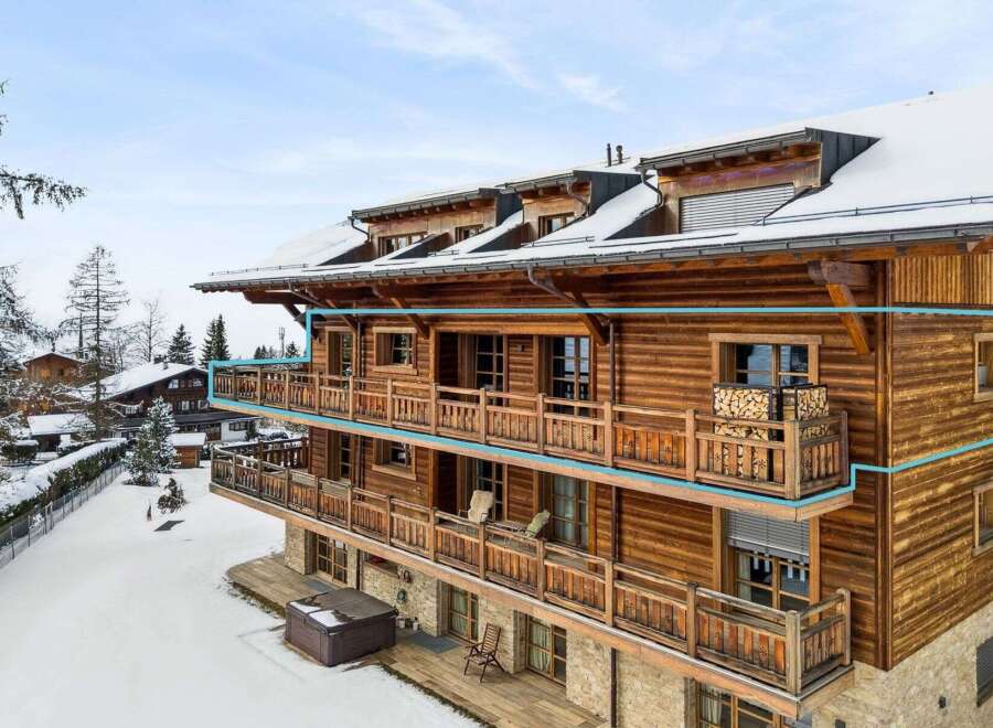 Experience luxury mountain living in this stunning wooden chalet, featuring expansive balconies perfect for enjoying breathtaking winter views.