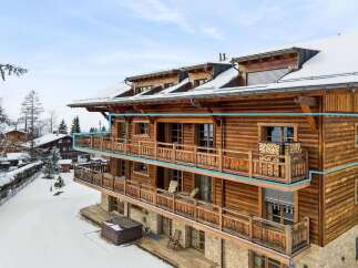Experience luxury mountain living in this stunning wooden chalet, featuring expansive balconies perfect for enjoying breathtaking winter views.