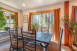 Enjoy meals with a view in this charming dining room, featuring a tile-top dining table and comfortable seating.