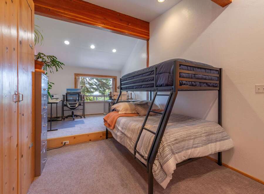 This charming bedroom features a space-saving bunk bed, perfect for accommodating guests or children.