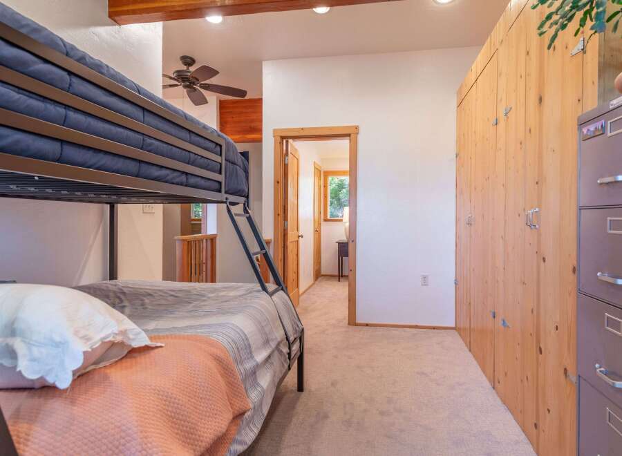 This charming bedroom features a space-saving bunk bed, perfect for families or guests.