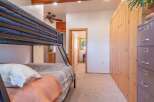 This charming bedroom features a space-saving bunk bed, perfect for families or guests.