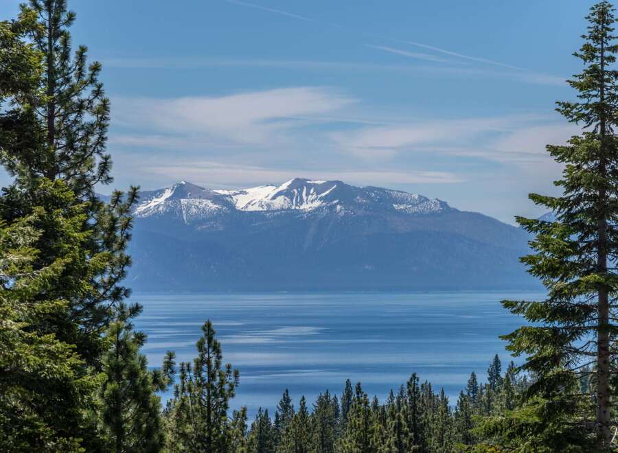 Experience breathtaking natural beauty with this stunning view of snow-capped mountains overlooking a serene lake.