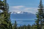 Experience breathtaking natural beauty with this stunning view of snow-capped mountains overlooking a serene lake.