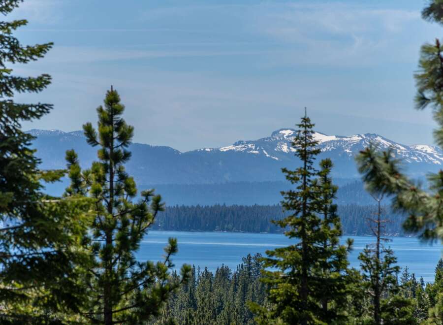 Experience breathtaking views of snow-capped mountains and a serene lake from this stunning property.