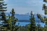 Experience breathtaking views of snow-capped mountains and a serene lake from this stunning property.