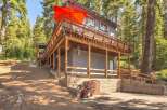 Nestled amidst tall pine trees, this multi-level home offers a unique mountain retreat.