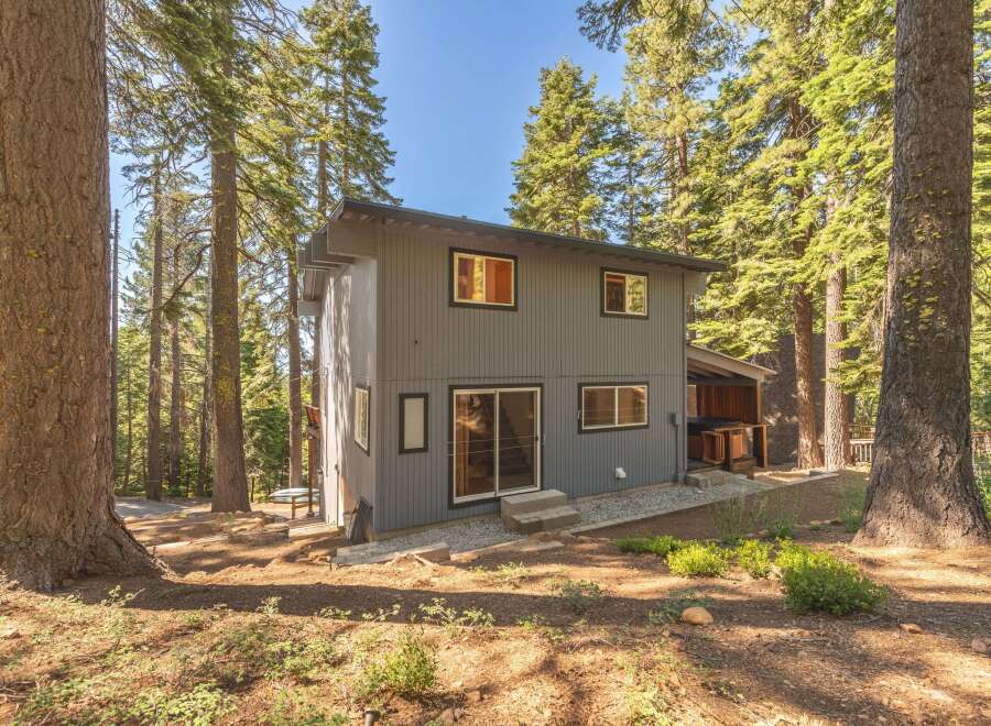 Nestled amongst towering pine trees, this modern home offers a serene retreat.