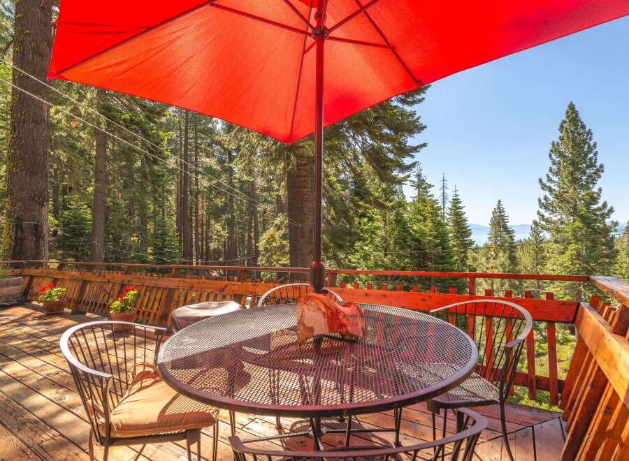Enjoy breathtaking mountain views from this expansive wooden deck, perfect for outdoor dining and relaxation.