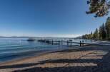 Experience lakeside luxury with this stunning property featuring a private dock and a serene beach area.