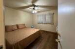 Discover this cozy bedroom featuring a comfortable bed with a patterned comforter and two plush pillows.
