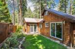 Nestled amongst tall pine trees, this charming cabin offers a serene retreat.