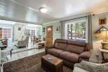 Step into this inviting living space featuring a comfortable brown leather sofa and a decorative trunk coffee table, perfect for cozy gatherings.
