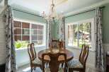 Enjoy intimate meals in this charming dining room, featuring a round wooden table perfect for gatherings.