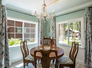 Enjoy intimate meals in this charming dining room, featuring a round wooden table perfect for gatherings.