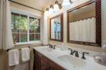 This charming bathroom features a spacious double vanity with elegant bronze fixtures, perfect for busy mornings.
