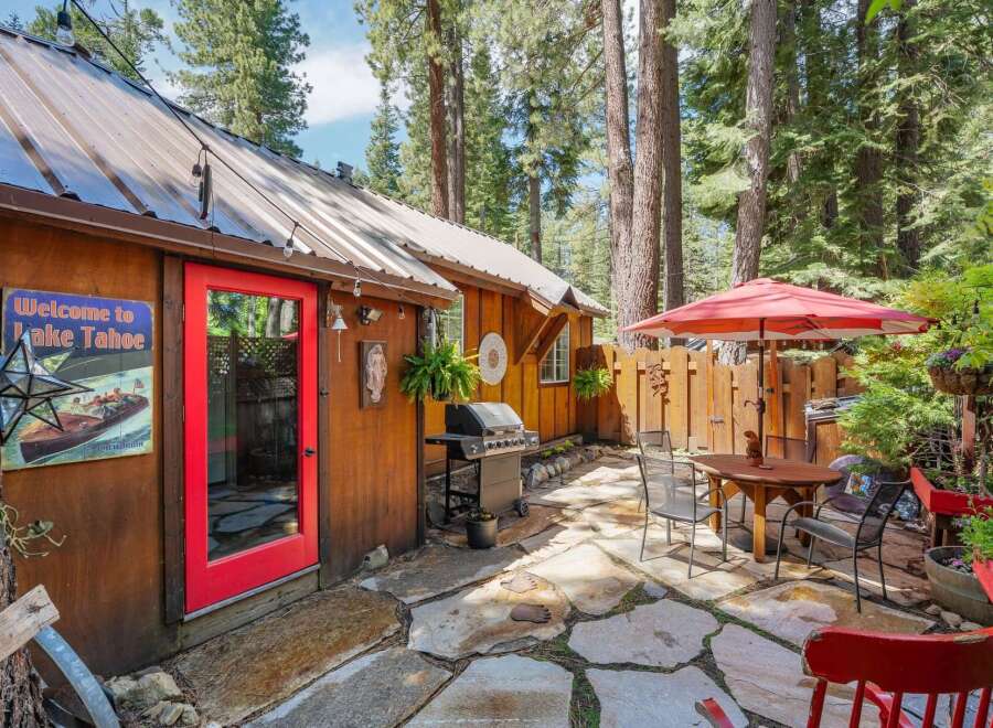 Enjoy outdoor living in this charming backyard featuring a spacious stone patio perfect for entertaining.