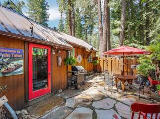 Enjoy outdoor living in this charming backyard featuring a spacious stone patio perfect for entertaining.