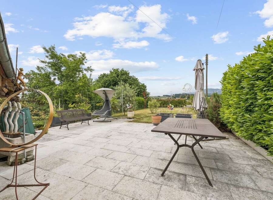 Enjoy outdoor living on this spacious patio, perfect for entertaining or relaxing.