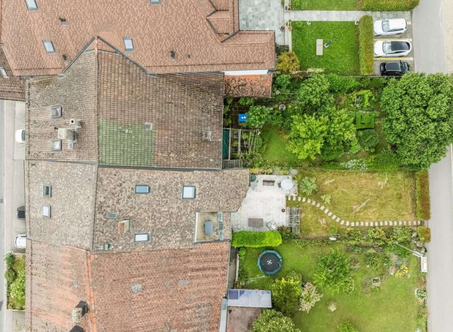 Discover this charming property featuring a spacious backyard with a trampoline and a paved patio area, perfect for outdoor entertaining.