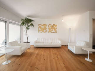 Experience modern living in this bright and airy living room, featuring a sleek white sofa and matching armchairs perfect for relaxation.