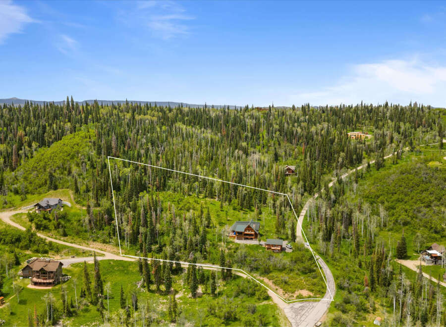 Discover this stunning mountain property, nestled amidst a lush forest of evergreen and aspen trees.
