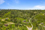 Discover this stunning mountain property, nestled amidst a lush forest of evergreen and aspen trees.