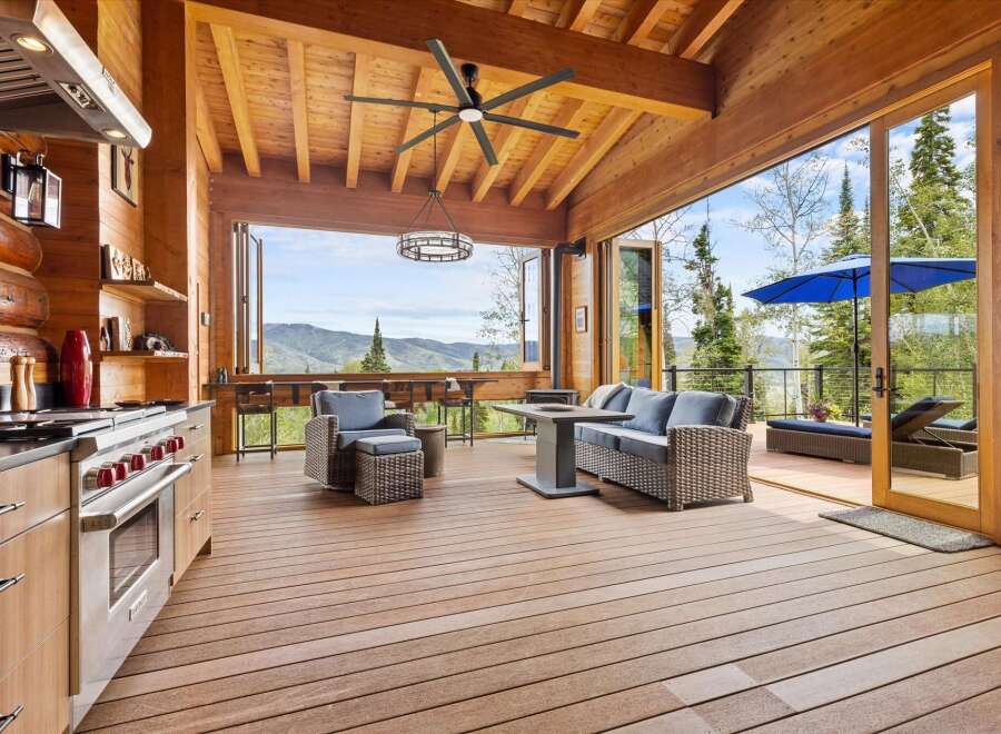 Experience seamless indoor-outdoor living in this stunning mountain retreat, featuring a gourmet kitchen that opens onto a spacious deck with breathtaking panoramic views.