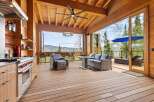 Experience seamless indoor-outdoor living in this stunning mountain retreat, featuring a gourmet kitchen that opens onto a spacious deck with breathtaking panoramic views.