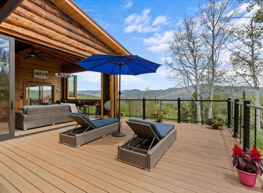 Experience breathtaking mountain views from this expansive deck, perfect for relaxation and entertaining.