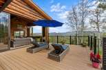 Experience breathtaking mountain views from this expansive deck, perfect for relaxation and entertaining.