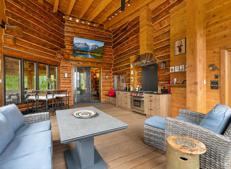Experience rustic luxury in this stunning log cabin featuring an open-concept living space with a gourmet kitchen and dining area.