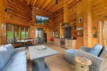 Experience rustic luxury in this stunning log cabin featuring an open-concept living space with a gourmet kitchen and dining area.