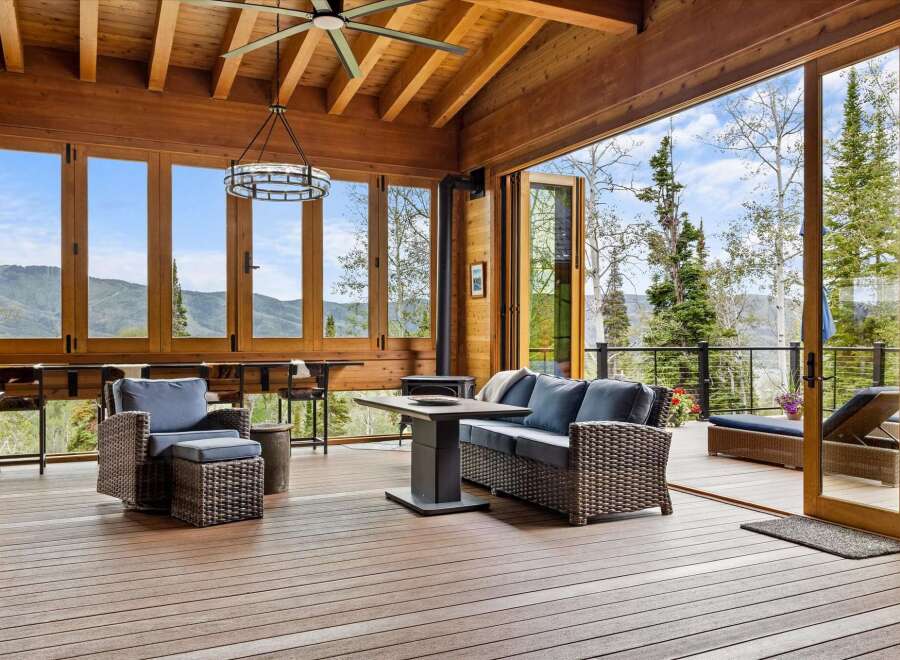 Experience breathtaking mountain views from this stunning covered deck, perfect for indoor-outdoor living.