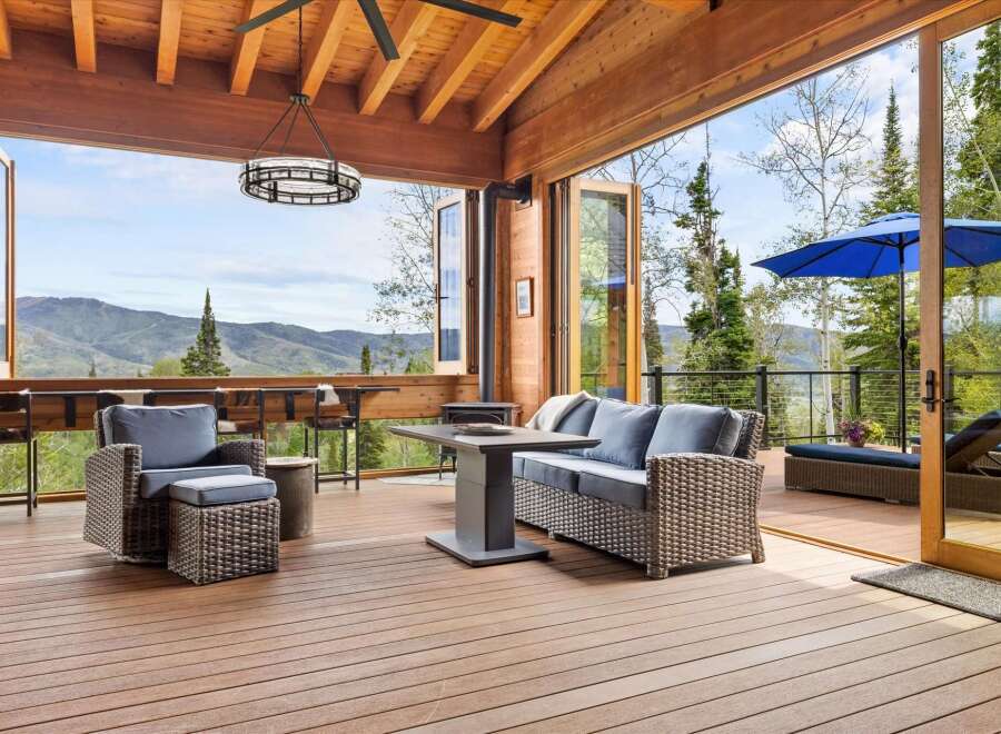 Experience breathtaking mountain views from this stunning covered deck, perfect for entertaining or relaxing.