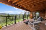 Enjoy breathtaking mountain views from this expansive covered deck, perfect for relaxing or entertaining.