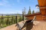 Enjoy breathtaking mountain views from this stunning log cabin deck, perfect for relaxing or entertaining.